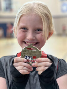 Kenzie with medal 225x300